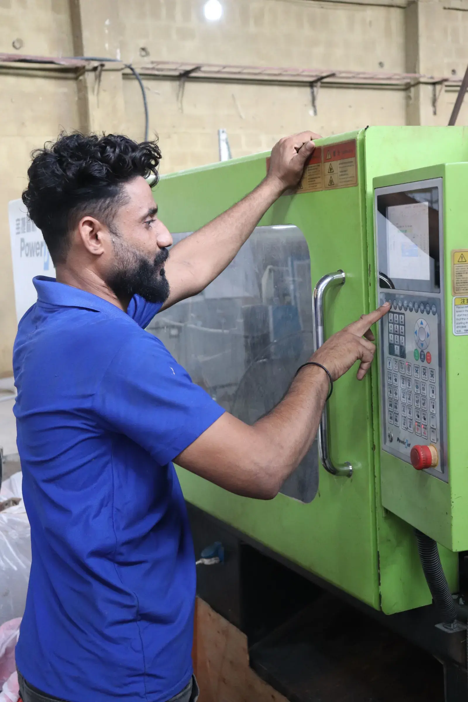 injection-moulding-operator-at-controls